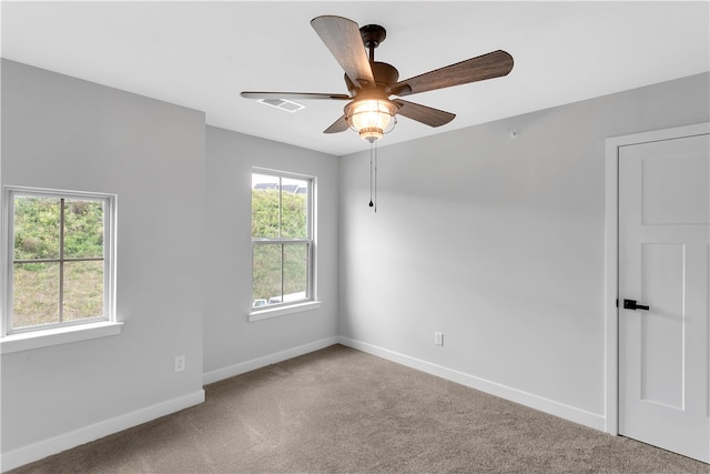 unfurnished room featuring ceiling fan and carpet