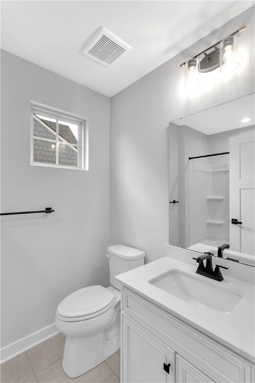 bathroom featuring vanity, a shower, toilet, and tile patterned floors