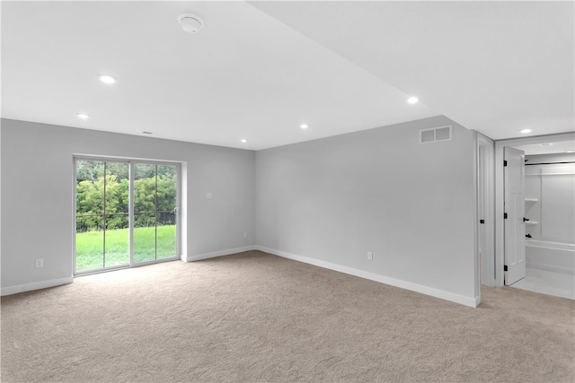 unfurnished room featuring light carpet