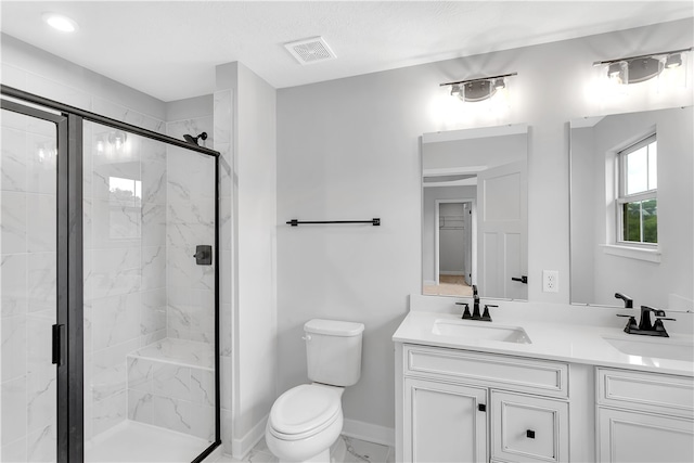 bathroom featuring vanity, toilet, and a shower with door