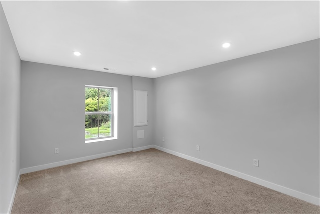 unfurnished room with light carpet