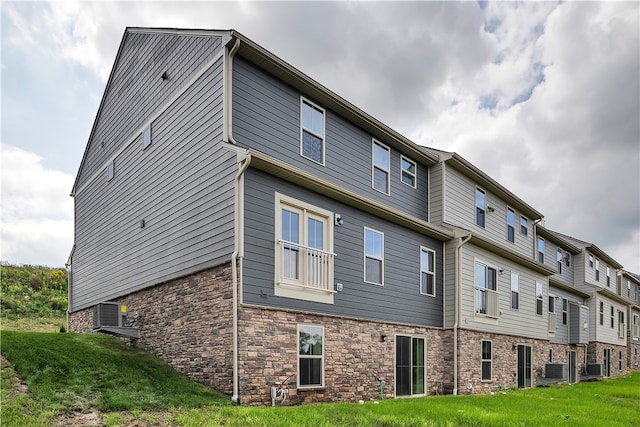 exterior space with a yard and central AC