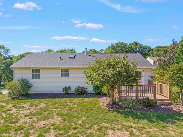 back of house with a yard and a wooden deck