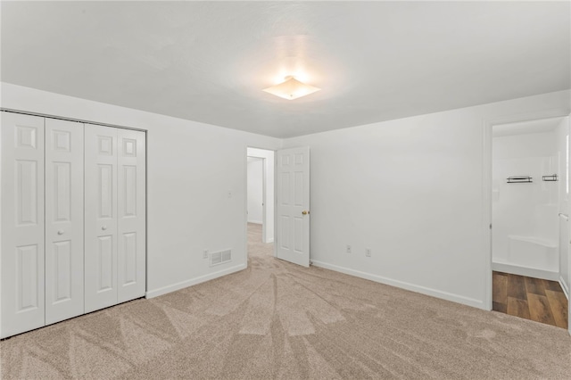 unfurnished bedroom with carpet floors and a closet