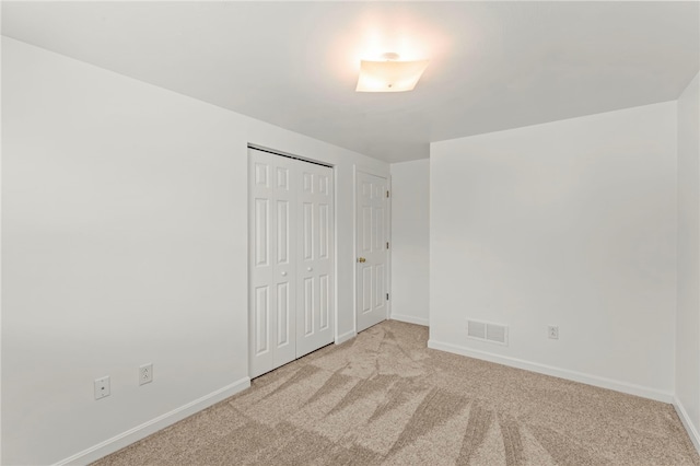 unfurnished bedroom with light carpet