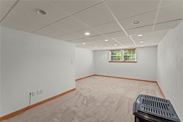 empty room featuring carpet floors and a paneled ceiling