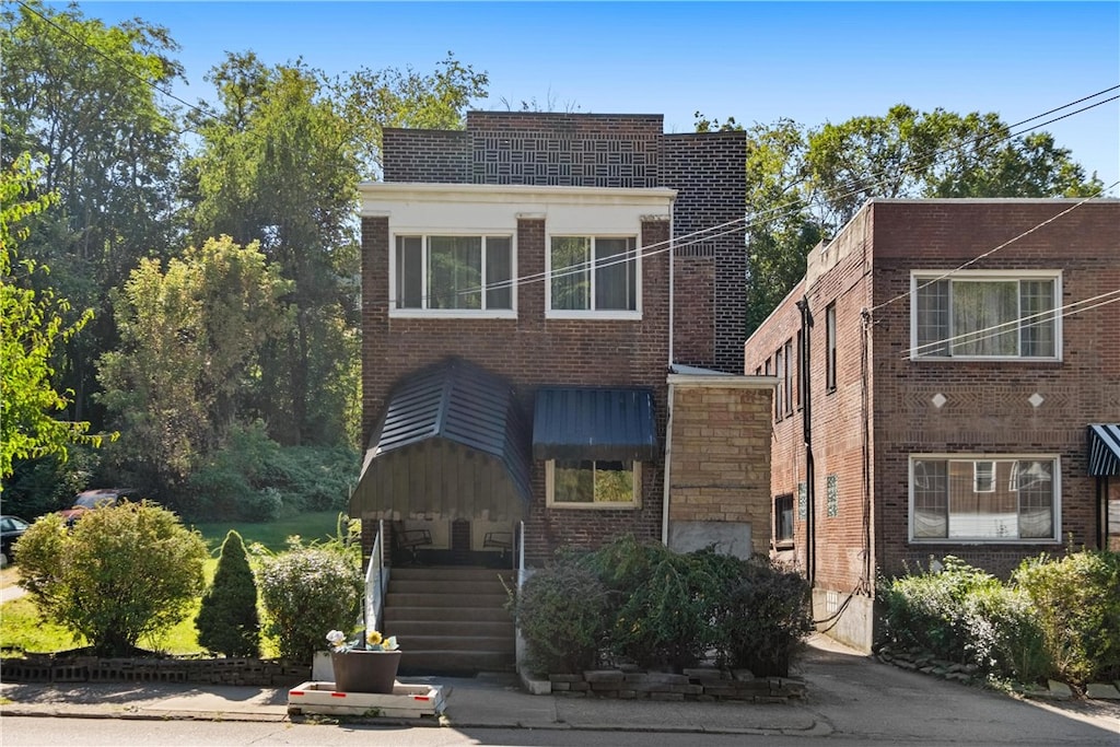 view of front of house featuring brick siding