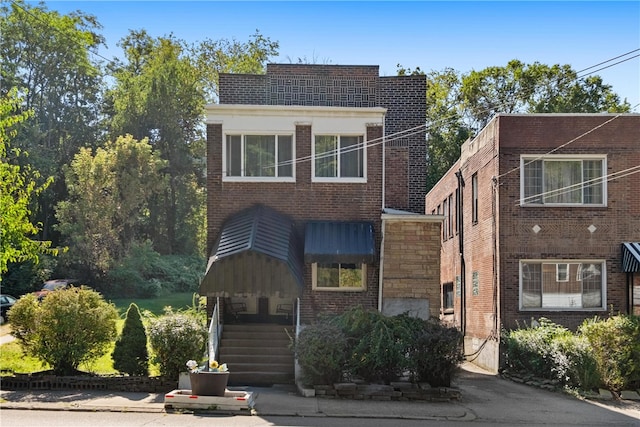 view of front of house featuring brick siding