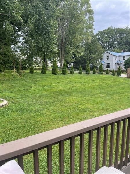 view of yard with a balcony