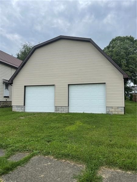 garage featuring a lawn