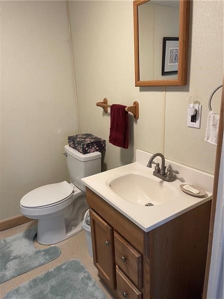 bathroom with vanity, toilet, and tile patterned flooring