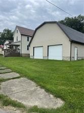 view of property exterior featuring a yard and a garage