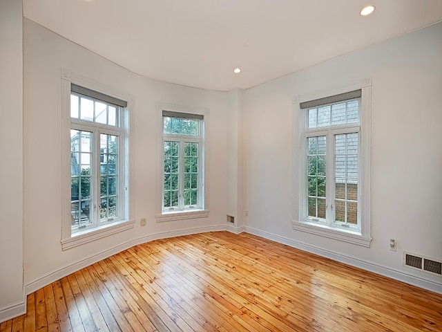 spare room with light hardwood / wood-style floors