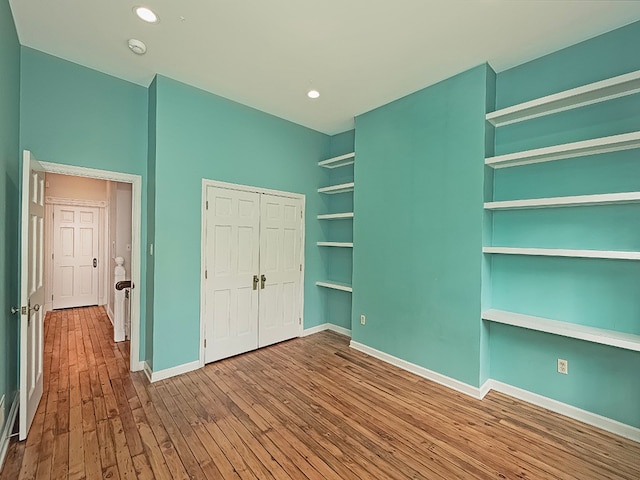 unfurnished bedroom with wood-type flooring