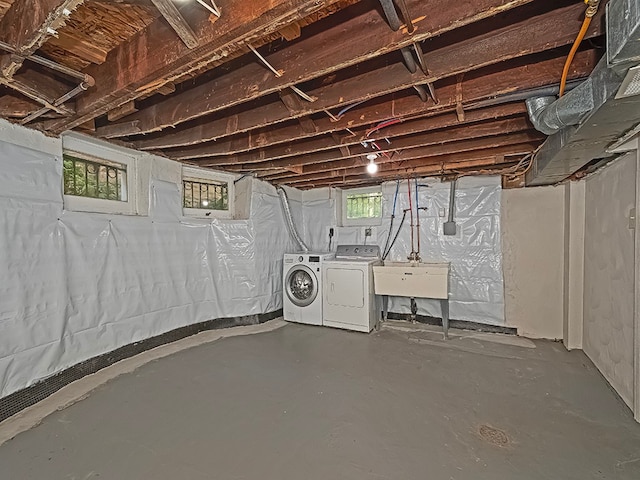 basement featuring washer and clothes dryer and sink