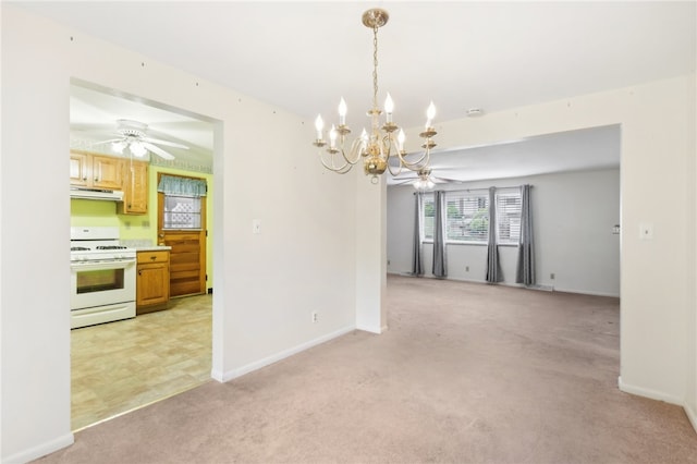 unfurnished dining area featuring ceiling fan with notable chandelier and light carpet