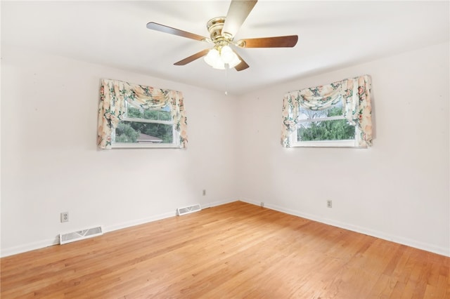 spare room featuring ceiling fan and hardwood / wood-style floors