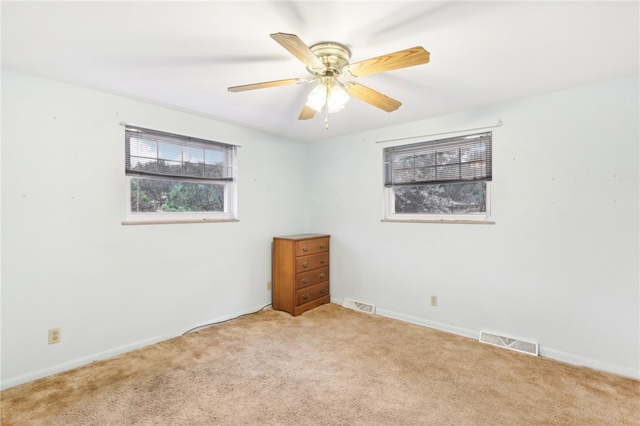 carpeted empty room featuring ceiling fan