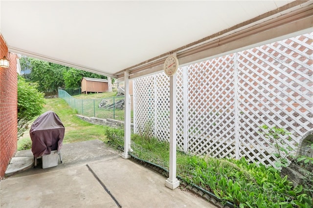 view of patio / terrace with grilling area and a shed