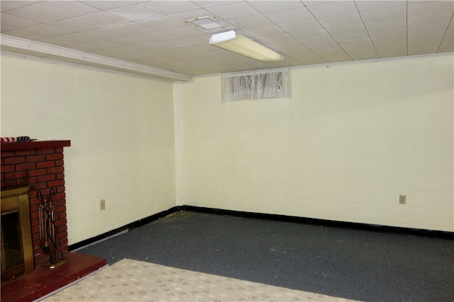 basement with carpet floors and a brick fireplace