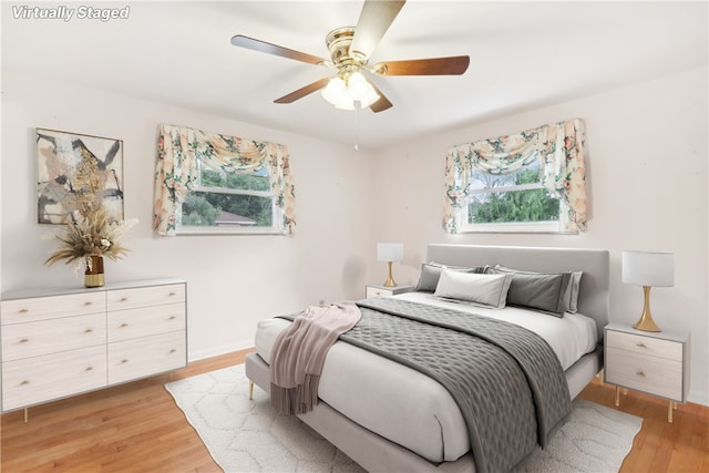 bedroom featuring ceiling fan and light hardwood / wood-style flooring