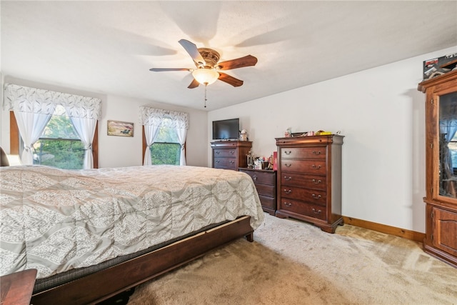 bedroom featuring ceiling fan and light colored carpet