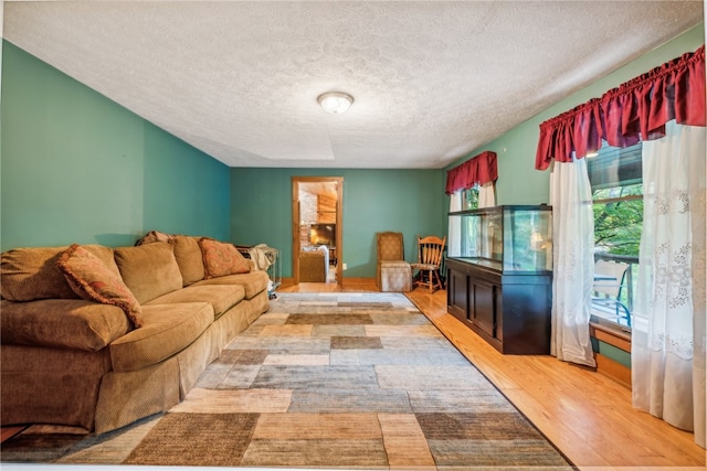 living room featuring a textured ceiling and light wood-type flooring