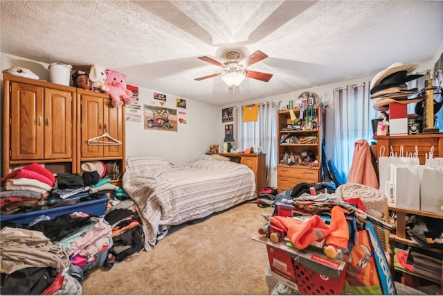 carpeted bedroom featuring ceiling fan and a textured ceiling