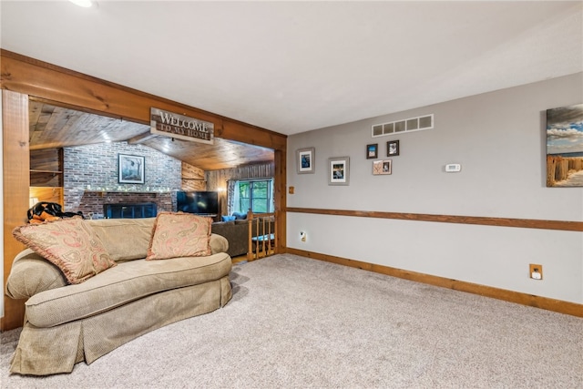 carpeted living room with lofted ceiling and a fireplace