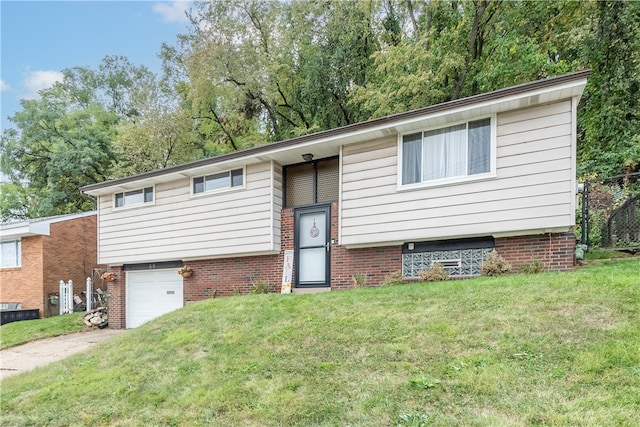 split foyer home with a garage and a front lawn