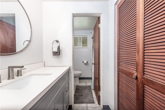 bathroom featuring vanity, toilet, and tile patterned floors