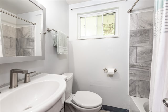 full bathroom featuring shower / bathtub combination with curtain, sink, and toilet