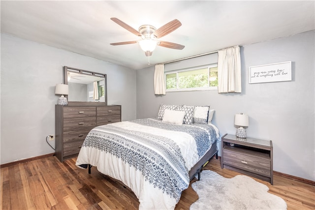 bedroom with ceiling fan and dark wood-type flooring