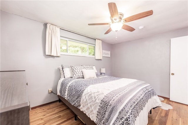 bedroom with light hardwood / wood-style floors and ceiling fan