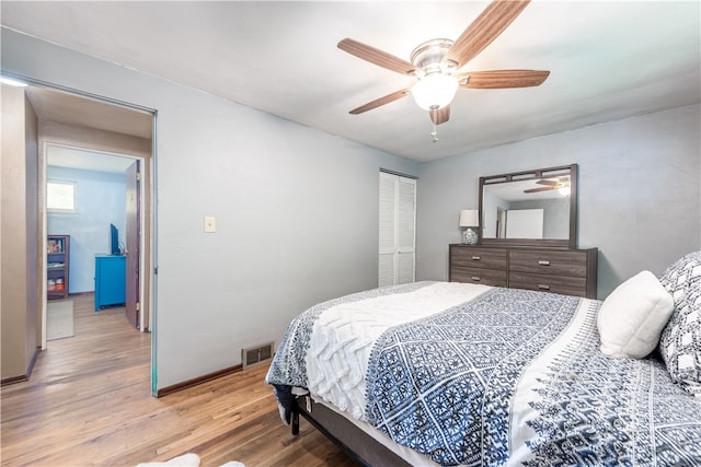 bedroom with wood-type flooring, a closet, and ceiling fan