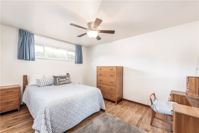 bedroom with light hardwood / wood-style floors and ceiling fan