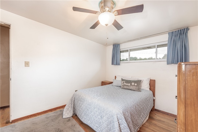 bedroom with light hardwood / wood-style flooring and ceiling fan