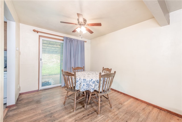 dining area with wood-type flooring and ceiling fan