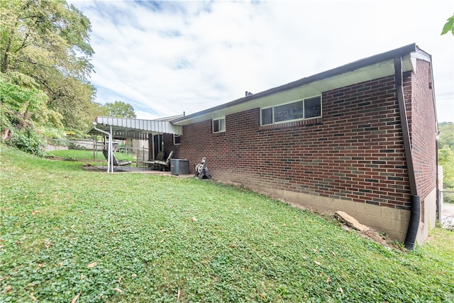 exterior space with a yard and central air condition unit