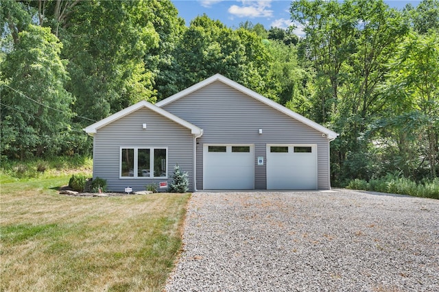 view of front of home featuring a front yard and a garage