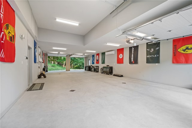 garage with a garage door opener and an AC wall unit