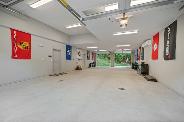 garage with a garage door opener and a wall mounted AC