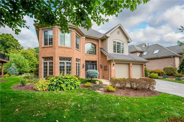 view of front of house with a front yard and a garage