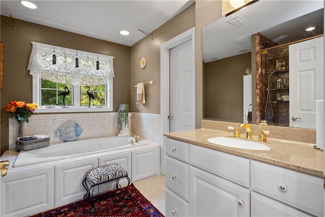 bathroom with independent shower and bath and vanity