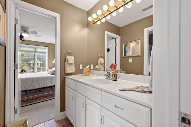 bathroom featuring ceiling fan, vanity, and tile patterned flooring