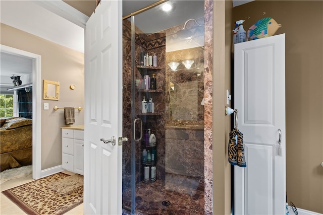 bathroom with walk in shower, vanity, and tile patterned floors