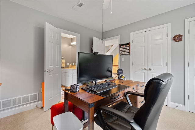 carpeted office featuring ceiling fan