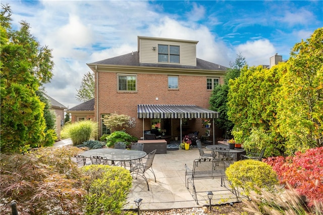 back of property with a patio