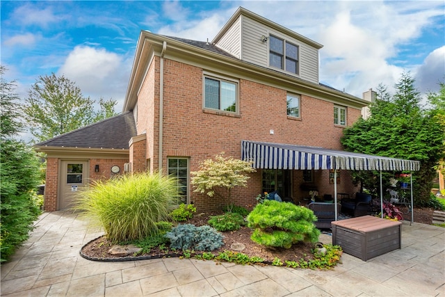 back of property with a patio