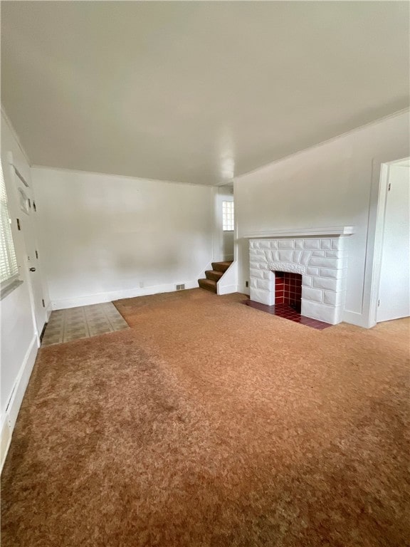 unfurnished living room featuring carpet flooring and a fireplace